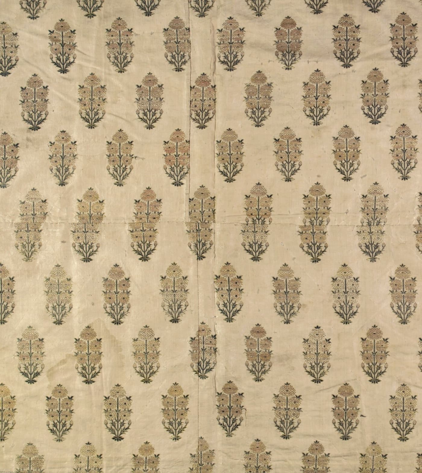 Ivory silk with upright rows of gold and green woven leaf butis
